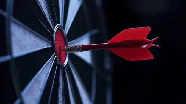 focused red arrow striking the bullseye on a dartboard symbolizing business success photo.jpg